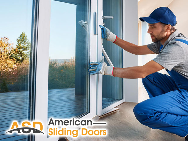 male professional technician working performing new installation of sliding door